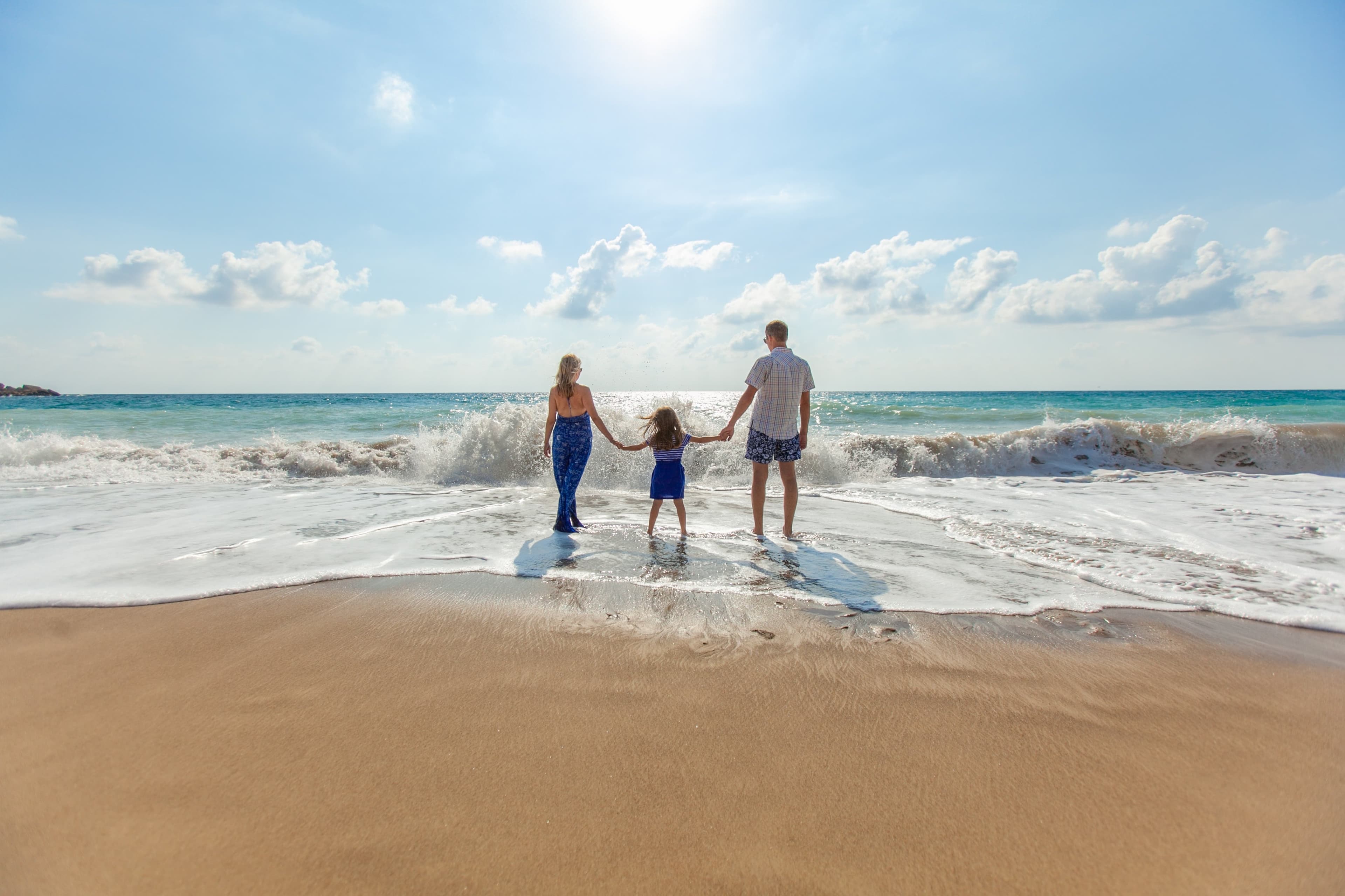 Policyfinder.ca homepage hero image 3: family of three on a beach